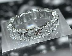 a diamond ring sitting on top of a clear box