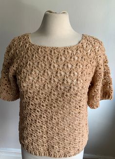 a crocheted top on a mannequin head