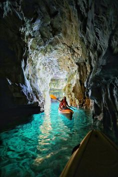 a person in a kayak is going through a cave