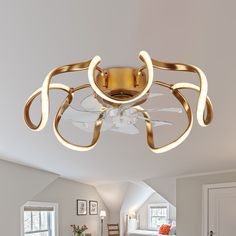 a living room with a bed and a ceiling light that has been designed to look like a spider