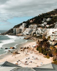 the beach is crowded with people and umbrellas