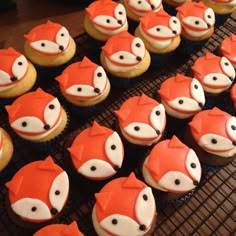 cupcakes with frosting decorated like foxes on cooling racks