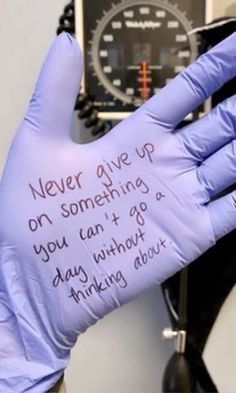 a gloved hand with writing on it that says never give up on something you can't go through