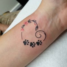 a person with a tattoo on their arm and paw prints in the shape of an elephant