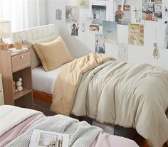 a bedroom with two beds and pictures on the wall