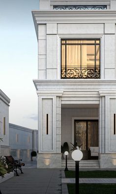 a white building with two balconies on the second floor