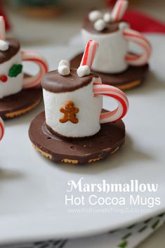 mini marshmallow hot cocoa mugs with candy canes and candies on top