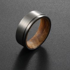 a wooden ring is shown on a black surface