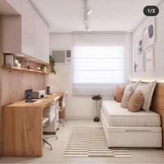 a room with a couch, desk and computer