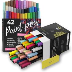 the 24 paint pens are next to each other in different colors and sizes, with one box full of them