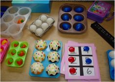 an assortment of toys such as cupcakes, eggs and other items on a table