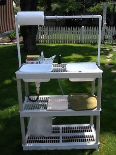 a white sink sitting on top of a metal shelf next to a green field with an american flag in the background