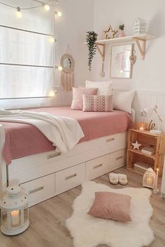 a bedroom with white walls and pink bedding