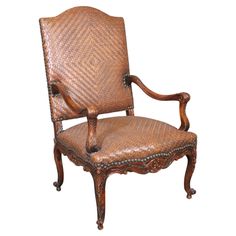 an old fashioned chair with leather upholstered back and arm rests against a white background