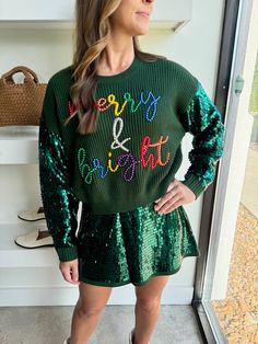 This Queen of Sparkles sweater blends festive sequins and colorful pearl detailing for a show-stopping holiday look. Need to know: Forest green ribbed knit body Colorful "Merry & Bright" slogan adorned with pearl embellishments Shiny sequin sleeves for extra holiday sparkle Relaxed fit for comfort and style Soft knit fabric perfect for seasonal celebrations How we are styling it:Pair this sweater with a sequin mini skirt for a bold holiday statement, or dress it down with denim and sneakers for a more casual festive look. Model info: Height: 5’6 Waist: 25” Bust: 34” Hips: 38” Model is wearing an XS Bright Sweater, Queen Of Sparkles, Sequin Mini Skirt, Sparkle Sweater, Sequin Sleeve, Holiday Sparkle, Fall Capsule Wardrobe, Sequin Mini Skirts, Holiday Looks