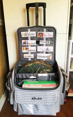 an open suitcase sitting on top of a hard wood floor next to a book shelf