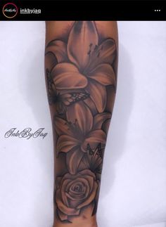 a woman's leg with flowers and butterflies on it