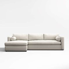 a white couch sitting on top of a white floor