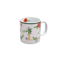 a white coffee cup with flowers and leaves on the inside, in front of a white background