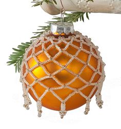 an ornament with a pine tree branch on it