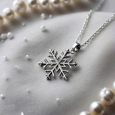 Celebrate the holiday season in style with this Unique Snowflake Necklace, a perfect blend of festive charm and modern elegance. Featuring a meticulously crafted Christmas Resin Necklace adorned with a delicate Snowflake Pendant, this piece is a winter wonderland in jewelry form. The shimmering resin captures the magic of snow, while the intricate snowflake design evokes the joy and spirit of Christmas. Ideal as a Christmas Statement Necklace, it effortlessly elevates any holiday outfit, making it a wonderful accessory for parties, gatherings, or as a thoughtful gift for loved ones. Embrace the season with this timeless Christmas Pendant Necklace that's as unique as a snowflake. Care instructions: * Keep Jewellery away from water, perfumes, deodorants, and other strong chemicals as they ma Intricate Snowflake, Timeless Christmas, Christmas Resin, Snowflake Necklace, Snowflake Pendant, Christmas Pendant, Necklace Indian, Snowflake Design, Snowflake Christmas