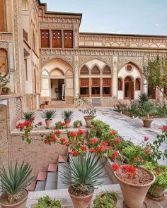 an outdoor courtyard with potted plants and flowers