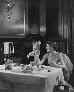 a man and woman sitting at a dinner table