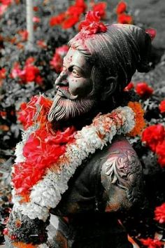 a statue of a man with flowers around his neck