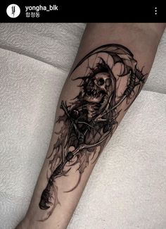 a person with a tattoo on their arm holding an arrow and skull in the background