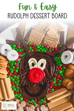 a christmas dessert board with chocolate, pretzels and marshmallows on it