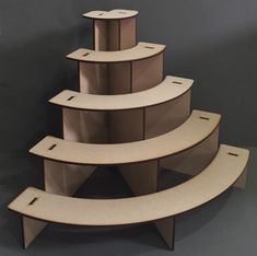 three wooden shelves stacked on top of each other in the shape of a pyramid,