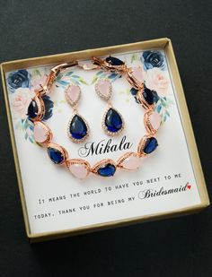 a blue and pink bracelet with matching earrings in a box that says, nisha i mean the world to have you next to me today thank you for being my beautiful