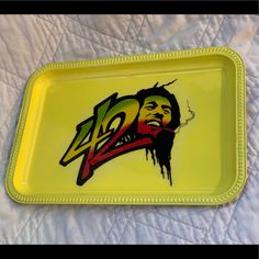 a yellow tray with a painting of a man's face on it