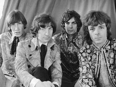 the rolling stones posing for a black and white photo