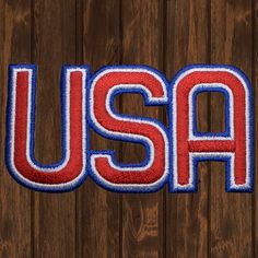 the word usa is made up of red, white and blue letters on a wooden background