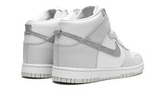 The Women’s Nike Dunk High “Silver Swoosh” is a women’s-exclusive colorway of the vintage basketball sneaker with a bold Swoosh logo.  Great for casual, everyday wear, the Dunk High’s “Silver Swoosh” colorway features a low contrast color scheme with white leather on the base and light grey on the overlays.  A glittery metallic silver Swoosh logo can be found on the sides of the sneaker.  Classic “Nike” detailing appears on the tongue.  Underfoot, the shoe is complete with a white rubber midsole Vintage Basketball, Nike Dunk High, Dunk High, Stadium Goods, Basketball Sneakers, Swoosh Logo, Nike Womens, Casual Everyday, Nike Dunk