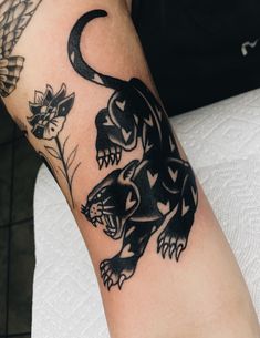 a black and white tattoo on the arm of a person with a dragon in it