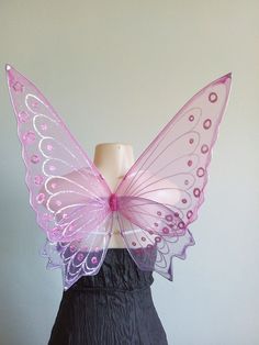 a dress form with a pink butterfly wings on it