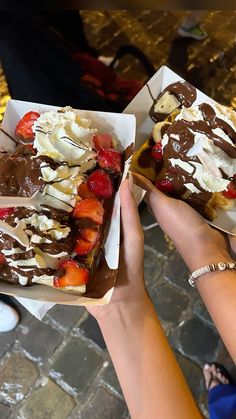 two people are eating desserts with chocolate and strawberries