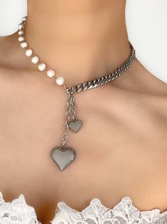 It's time for a heart to heart... you NEED this necklace in your life. Featuring two stunning puffed heart pendants paired alongside freshwater pearls and stainless steel chain, you’ll make jaws drop every time you wear this piece! Made with genuine freshwater pearls, stainless steel pendants and chain. Waterproof & rust-free. Available in lengths 14", 15", 16", 18", 20". All lengths include a 2" extension chain Model is wearing 16". Handmade with love in Los Angeles. Trendy Pearl Chain Necklace For Valentine's Day, Silver Heart-shaped Pearl Chain Necklace, Trendy Pearl Jewelry For Valentine's Day, Trendy Valentine's Day Pearl Jewelry, Heart-shaped Silver Necklace With Pearl Charm, Silver Heart Pendant With Pearl Drop, Silver Pearl Necklaces With Heart Charm, Silver Heart Necklace With Pearl Charm For Gift, Silver Pearl Heart Necklace With Pearl Charm