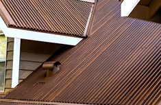 a bird is perched on the roof of a house