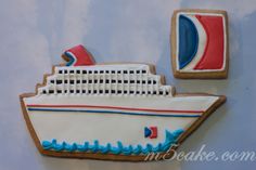 a decorated cookie with a cruise ship on it and a biscuit in the shape of a cookie