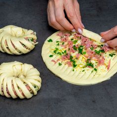 a person making food on top of a pizza crust with ham and green onions in the middle