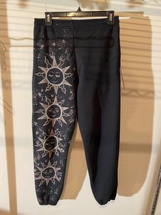 black pants with sun and moon designs on them