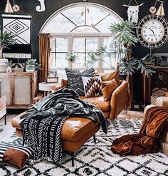 a living room filled with lots of furniture and decor on top of a white rug