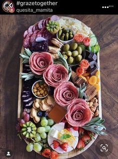 a platter filled with lots of different types of food on top of a wooden table