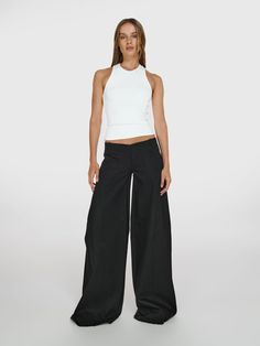 Full shot of a girl in a white viscose tank top and black wide leg jeans with low rise Ultra Low Rise Pants, Black Low Rise Pants, Low Rise Black Pants, Slouchy Pants, Low Rise Pants, Slow Fashion Brands, Icon Collection, Black Trousers, Wide Legs