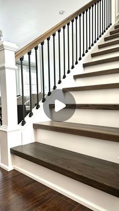 an empty staircase with wooden steps and handrails