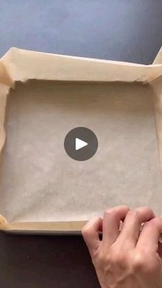 someone is opening up a cardboard box with something in the bottom that looks like an empty tray