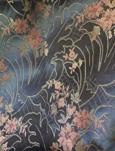 the fabric is blue and has pink flowers on it, with gold trimmings